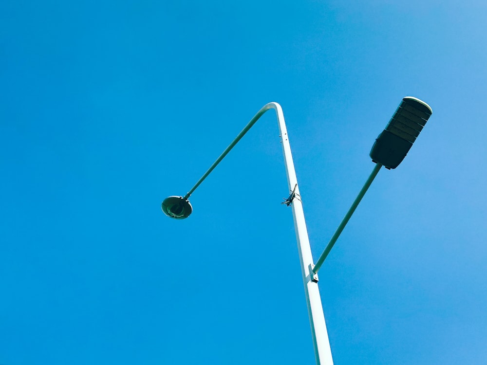 a street light with a blue sky in the background