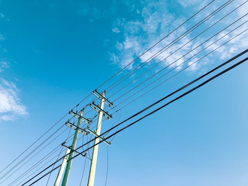 power lines and telephone poles against a blue sky