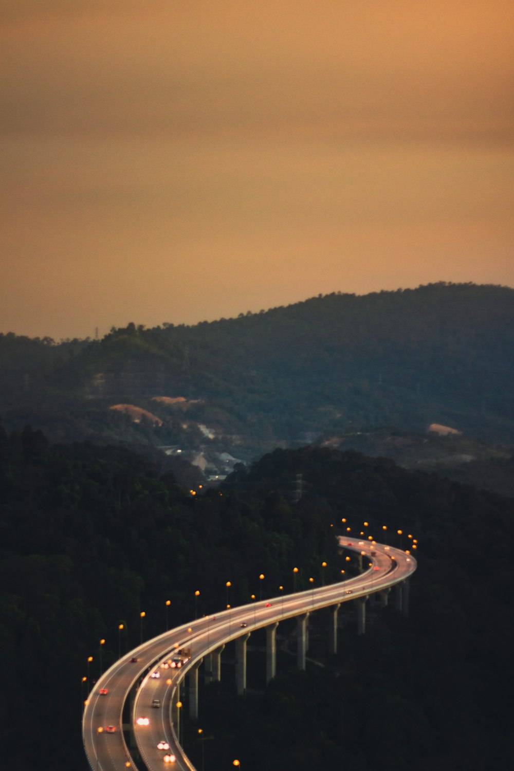 a highway going over a bridge in the middle of the night