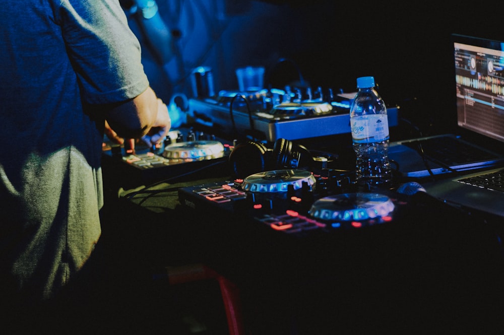 a dj mixing music in front of a laptop computer