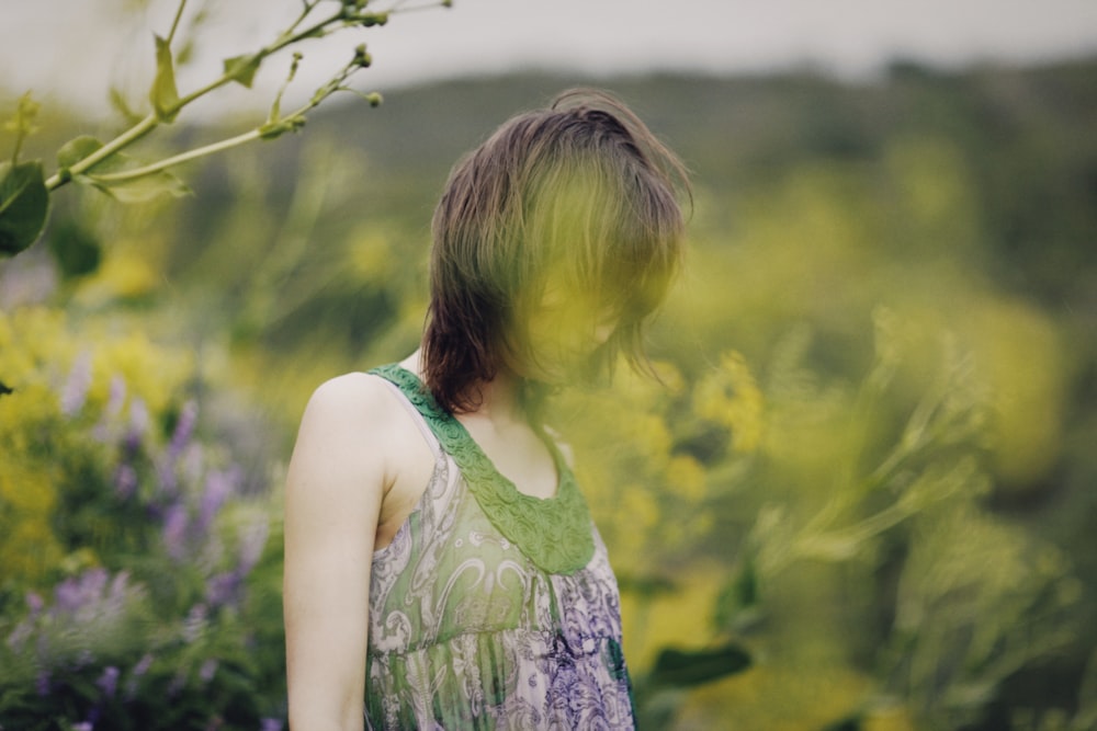 a woman standing in a field of flowers