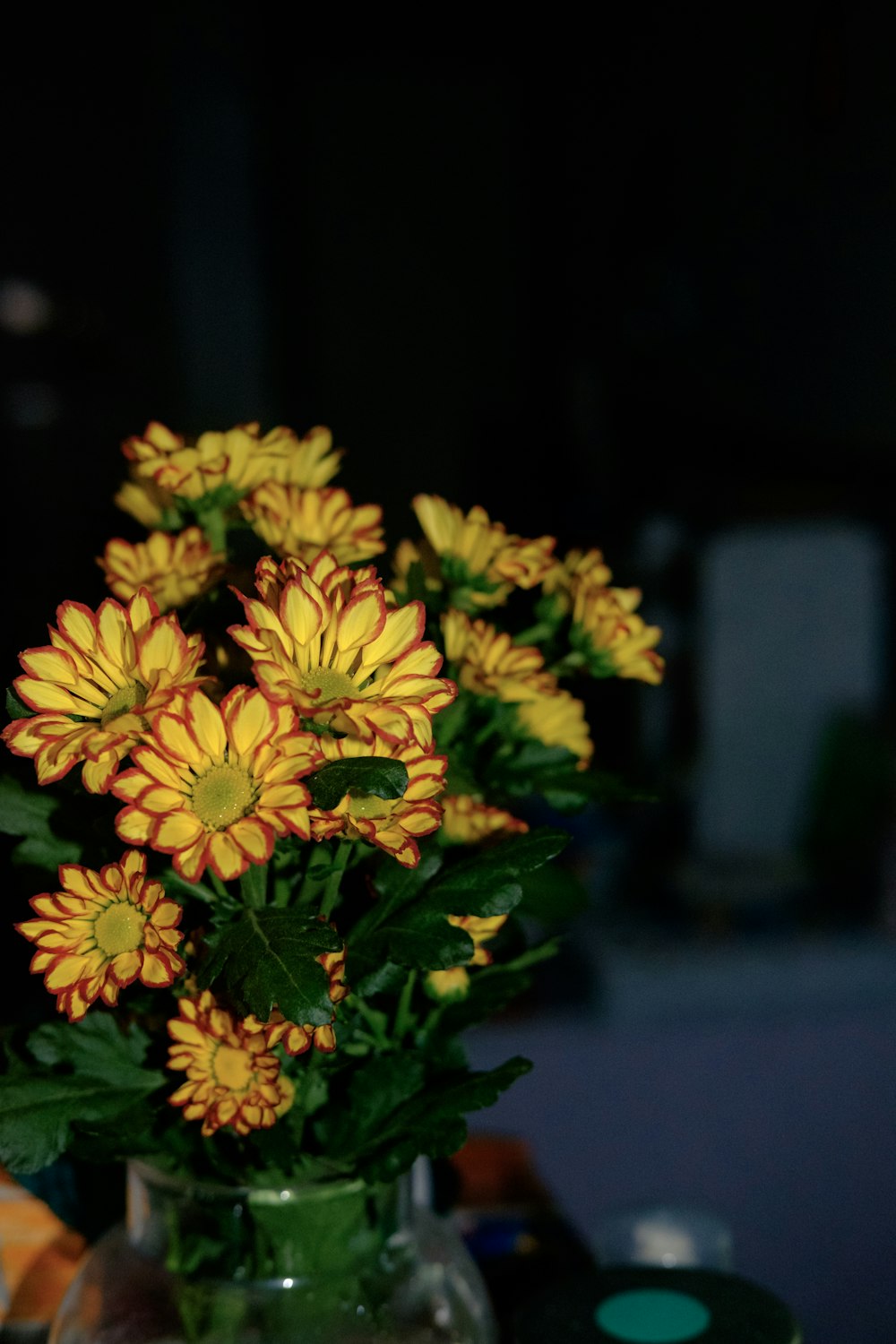 a vase filled with yellow flowers on top of a table