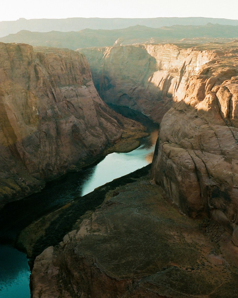 a river in a canyon surrounded by mountains