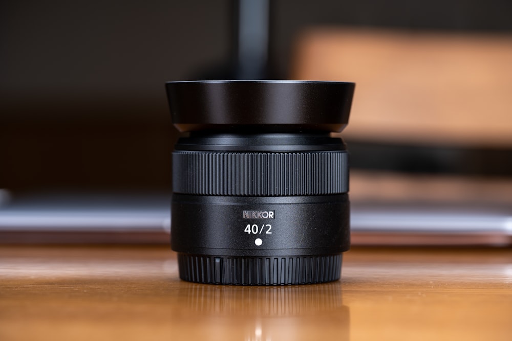 a camera lens sitting on top of a wooden table