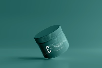 a jar of cream on a green background
