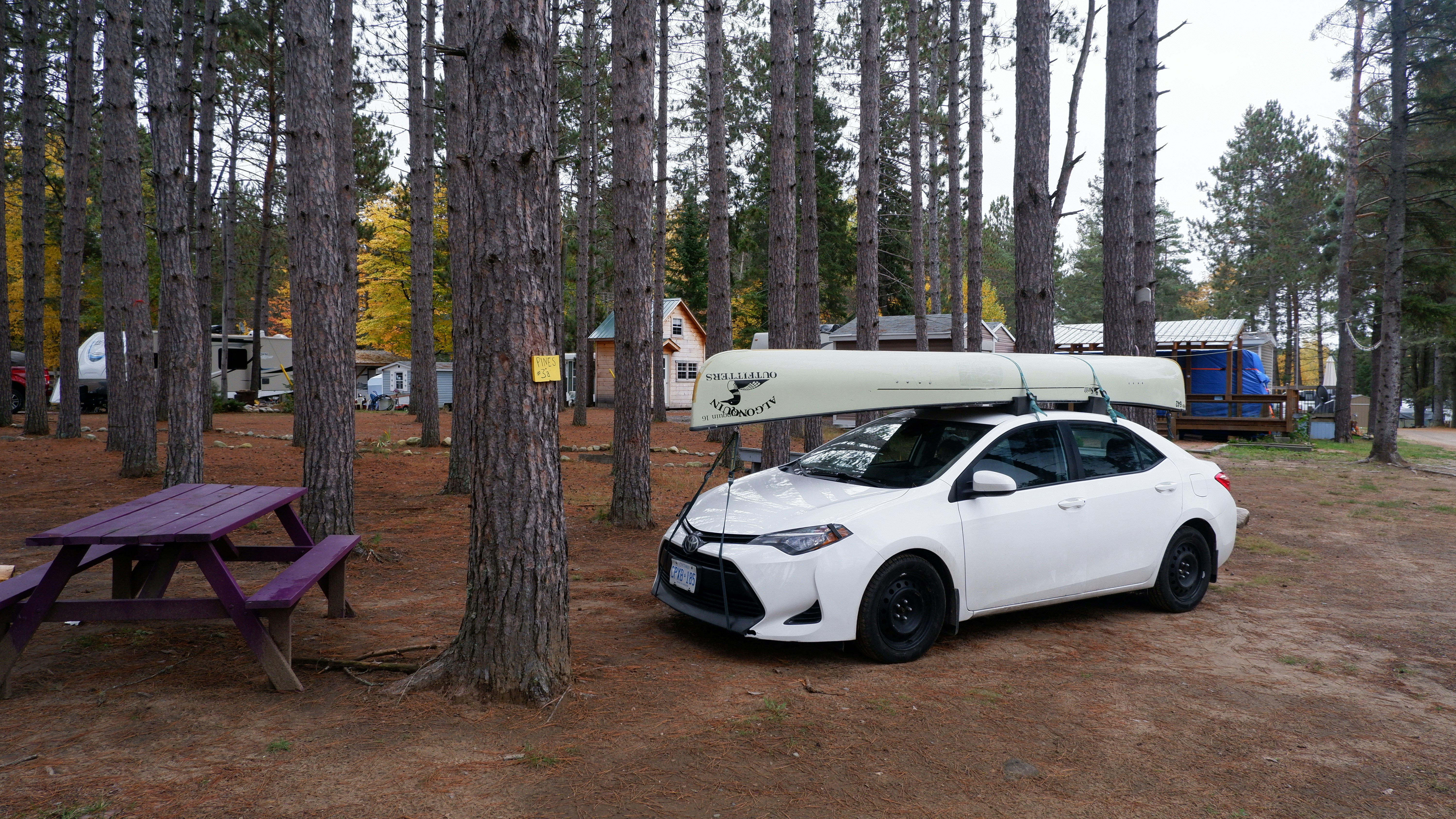 a white car with a kayak on top of it