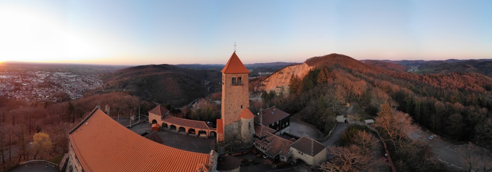 an aerial view of a church in the mountains