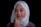 a woman wearing a headscarf poses for a picture