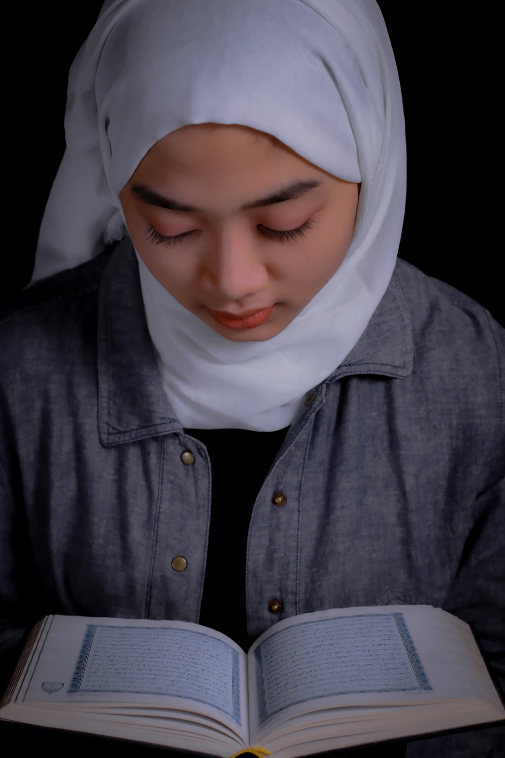 A young woman reading the Quran