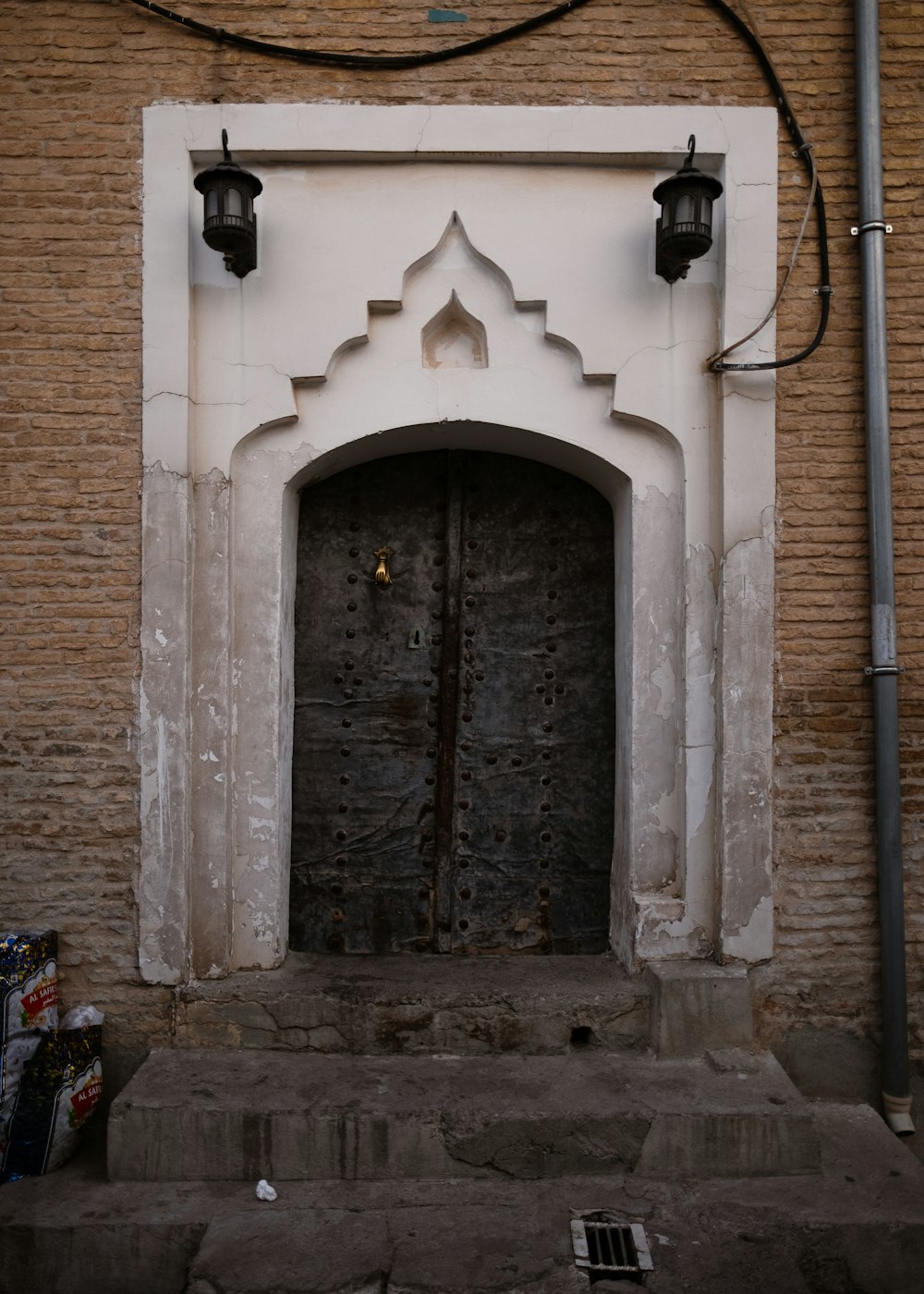 a doorway in a brick wall with a light on it