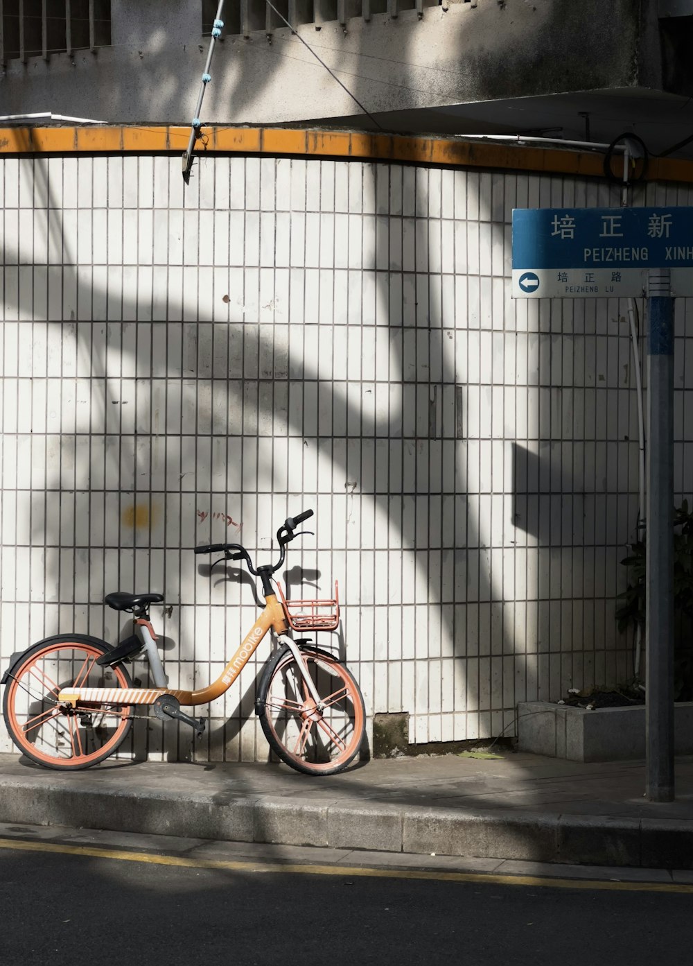a bicycle is parked next to a wall