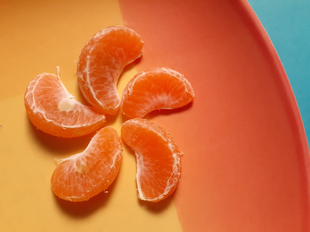 a group of oranges sitting on top of a plate