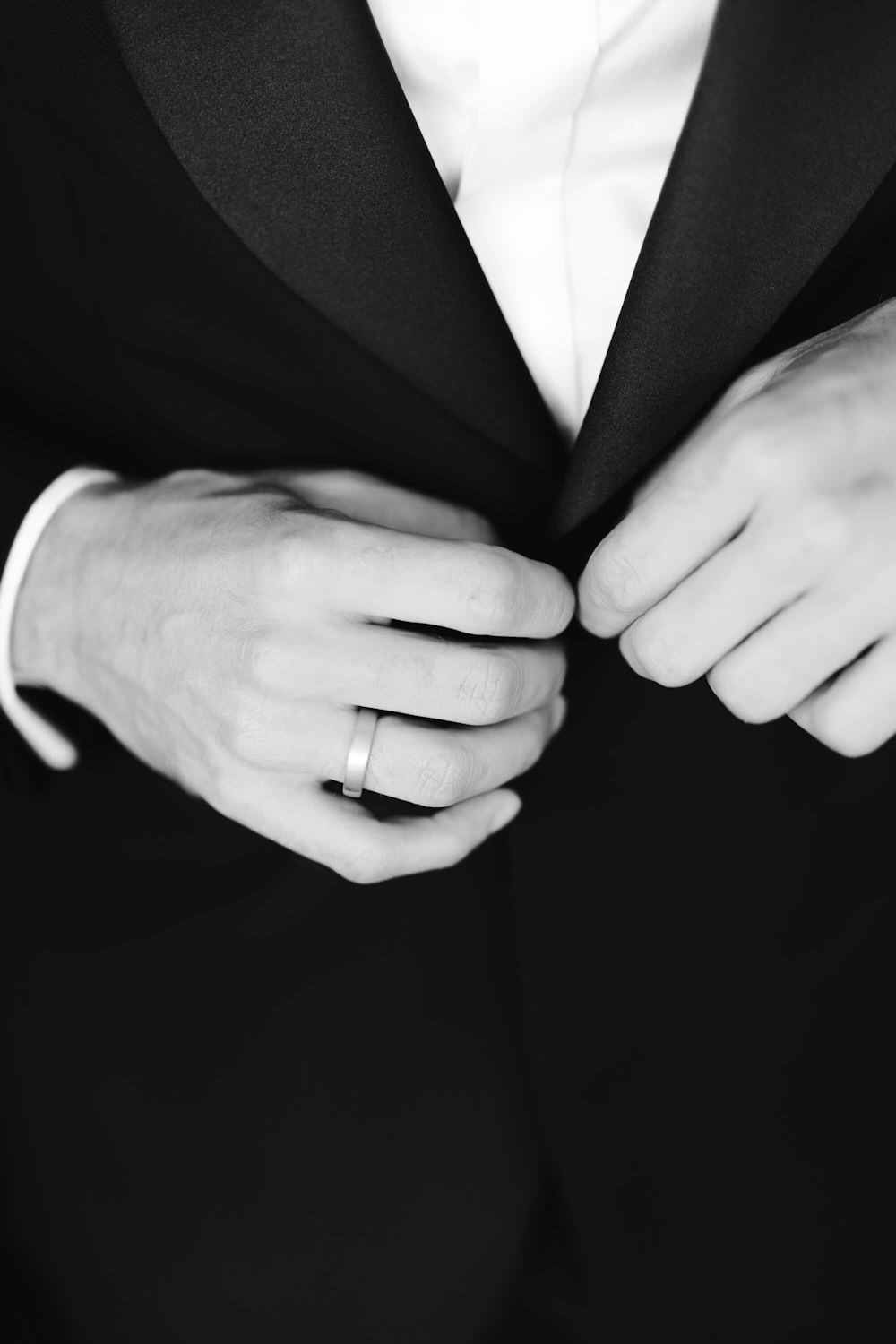 a close up of a person wearing a suit and tie