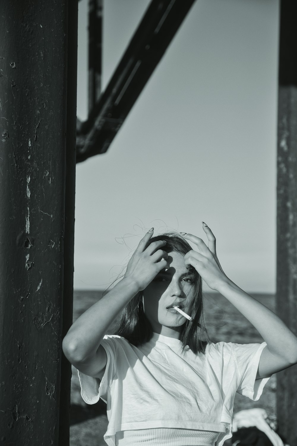 a black and white photo of a woman brushing her hair