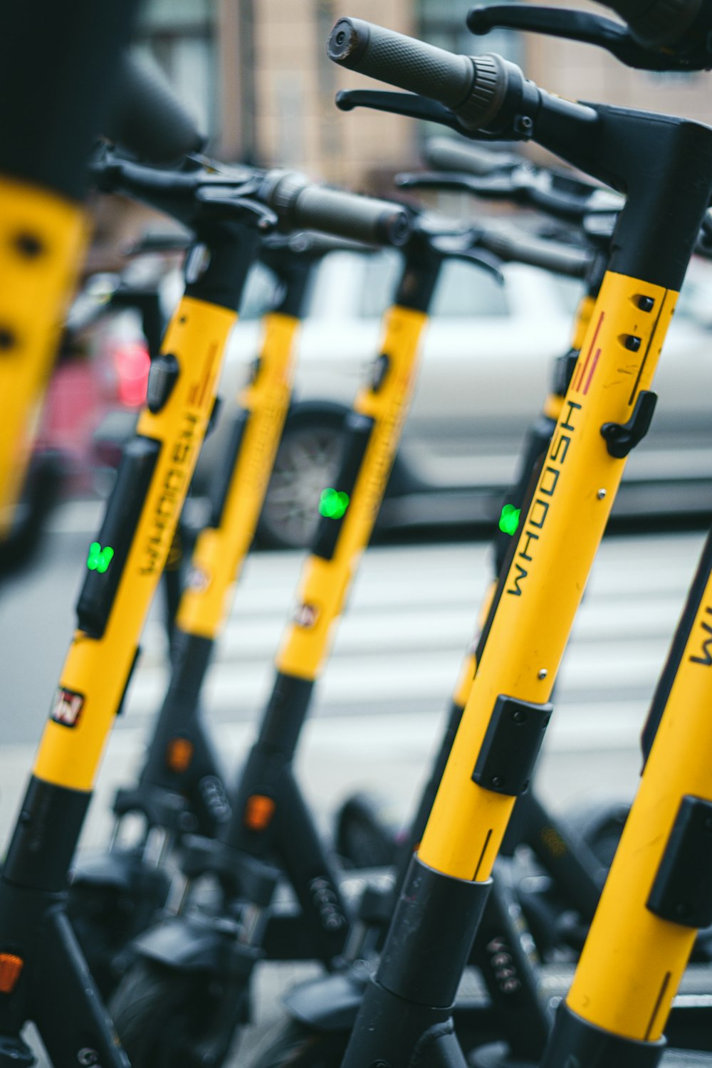 a row of yellow and black scooters parked next to each other