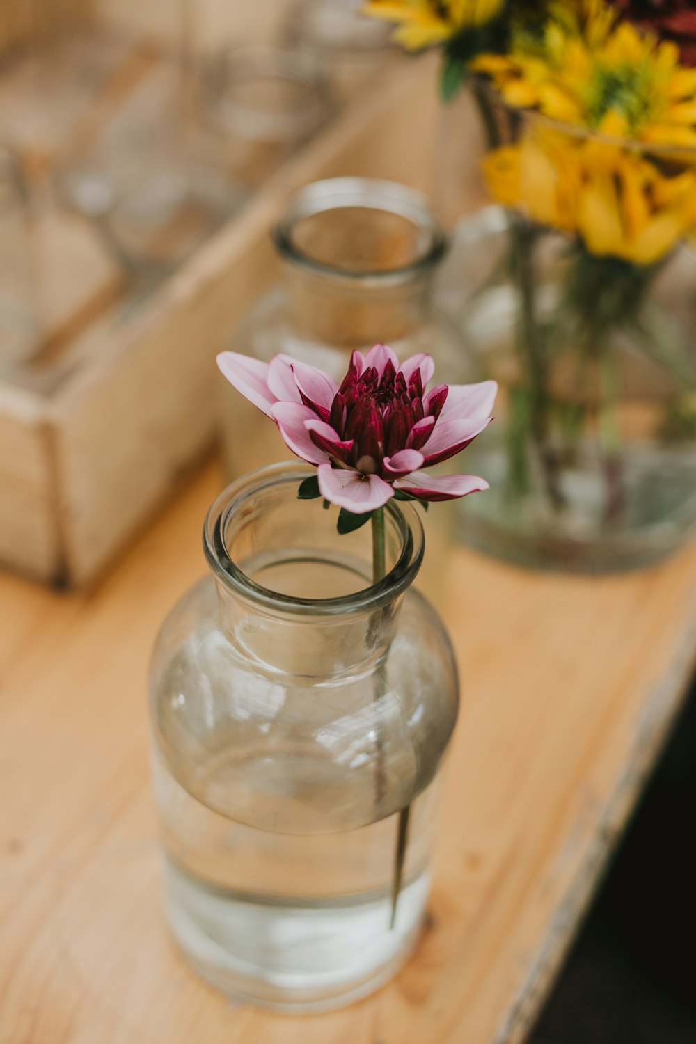 a vase with a flower in it sitting on a table