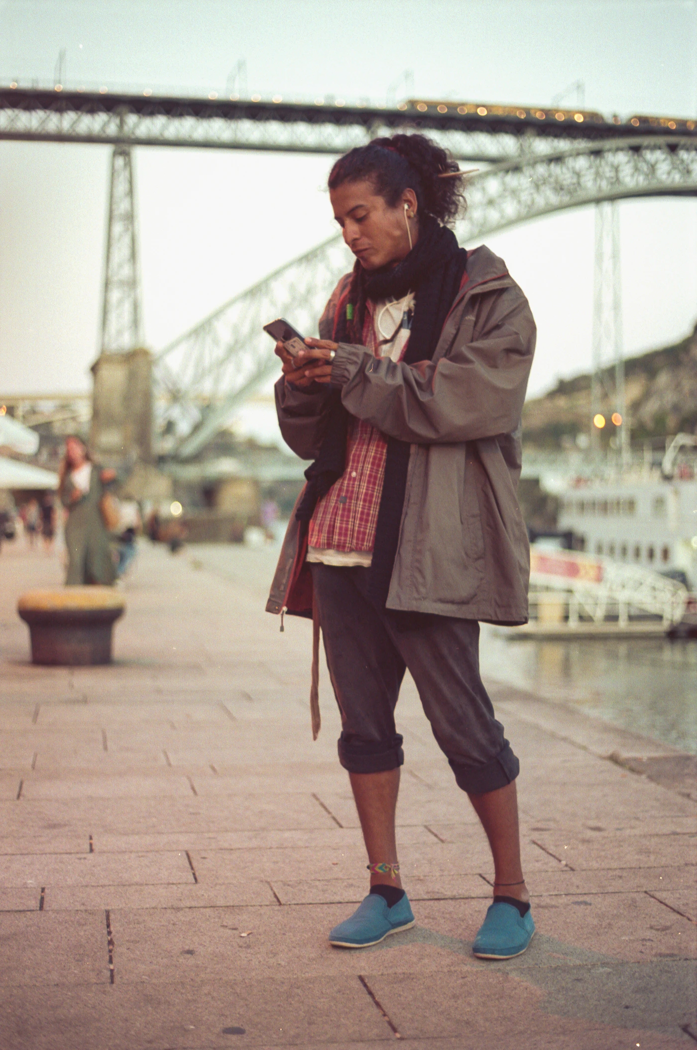 A woman on a sidewalk looking at her phone