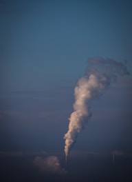 a smokestack emits from the top of a building