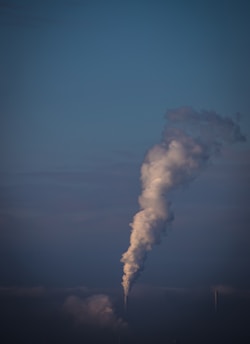 a smokestack emits from the top of a building