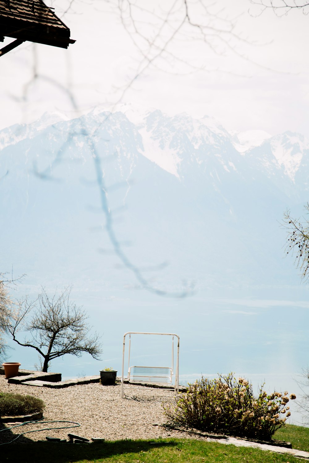 a grassy area with a soccer goal and mountains in the background