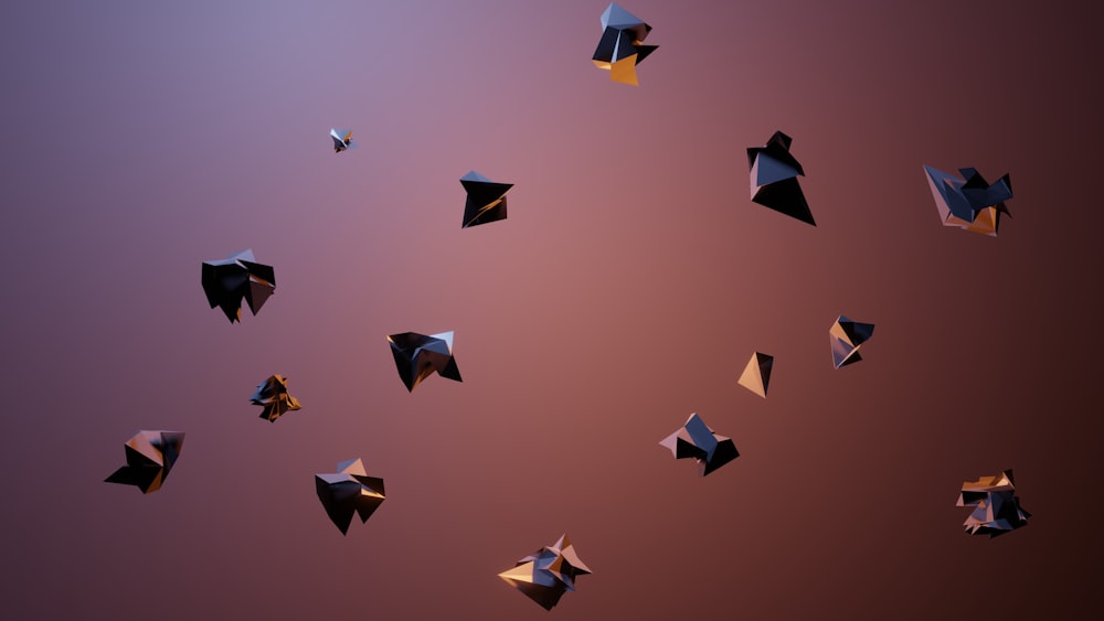 a group of black and gold objects floating in the air