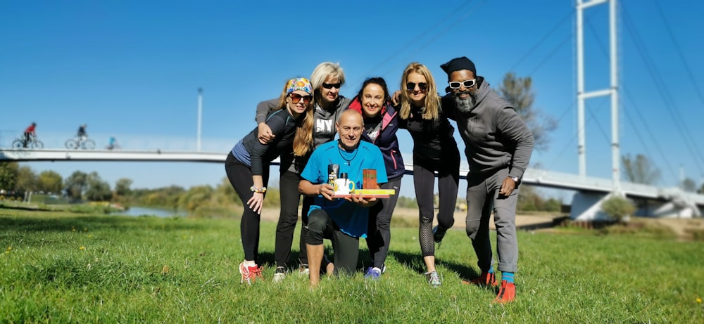 a group of people posing for a picture in a field