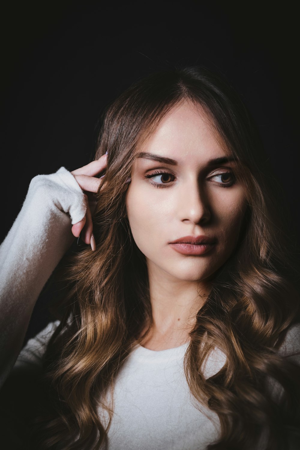 a woman with long hair and a white shirt