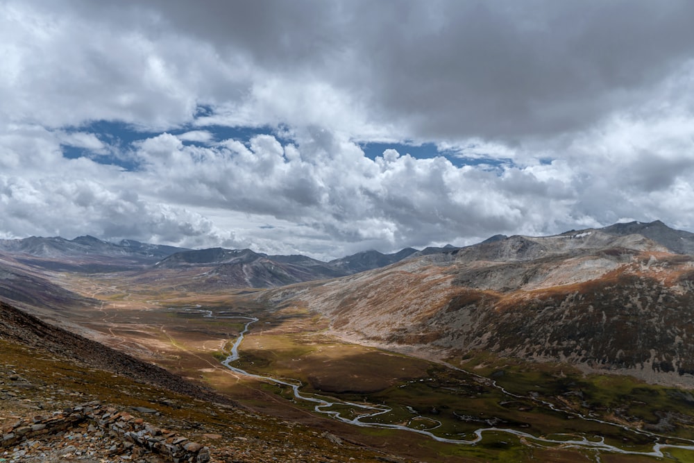 a scenic view of a valley and mountains