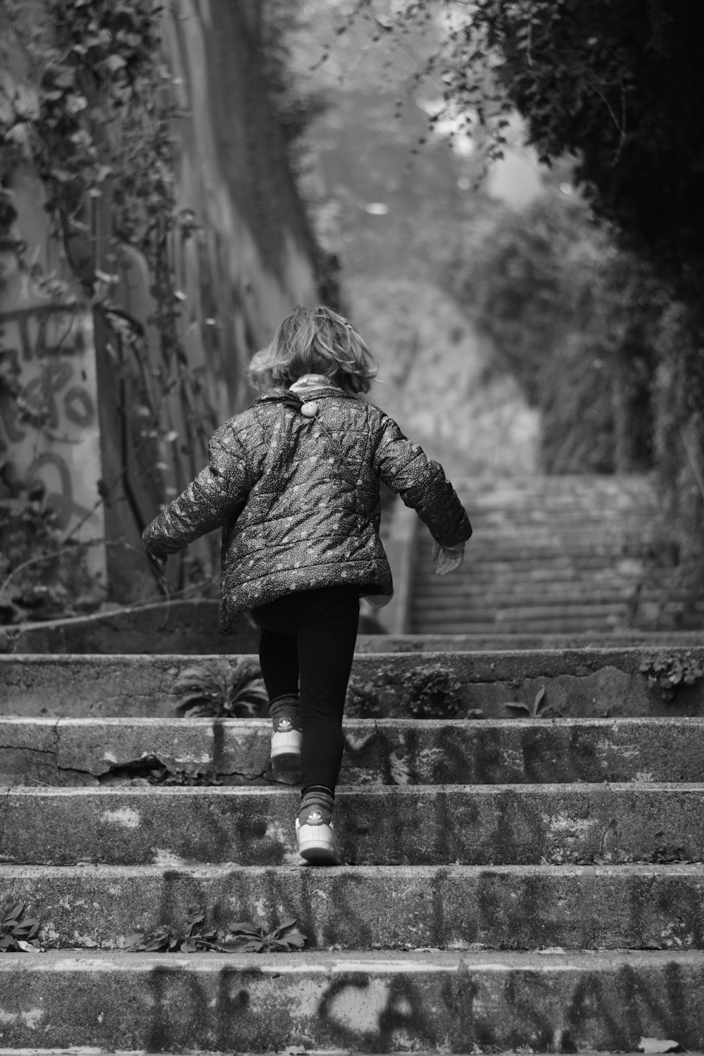 a little girl that is walking down some steps
