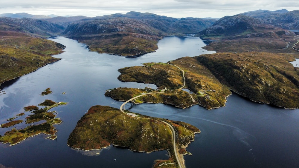 an aerial view of a large body of water surrounded by mountains