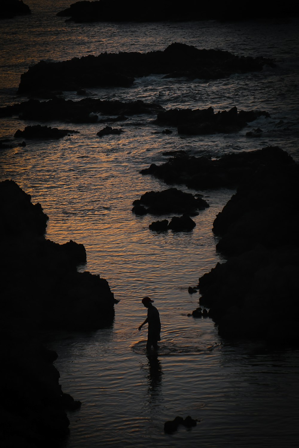 a person standing in the water with a surfboard