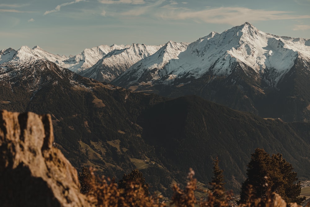 a mountain range with snow covered mountains in the background