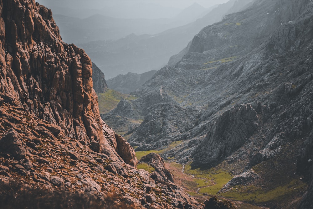 a view of a rocky mountain with a valley in the distance