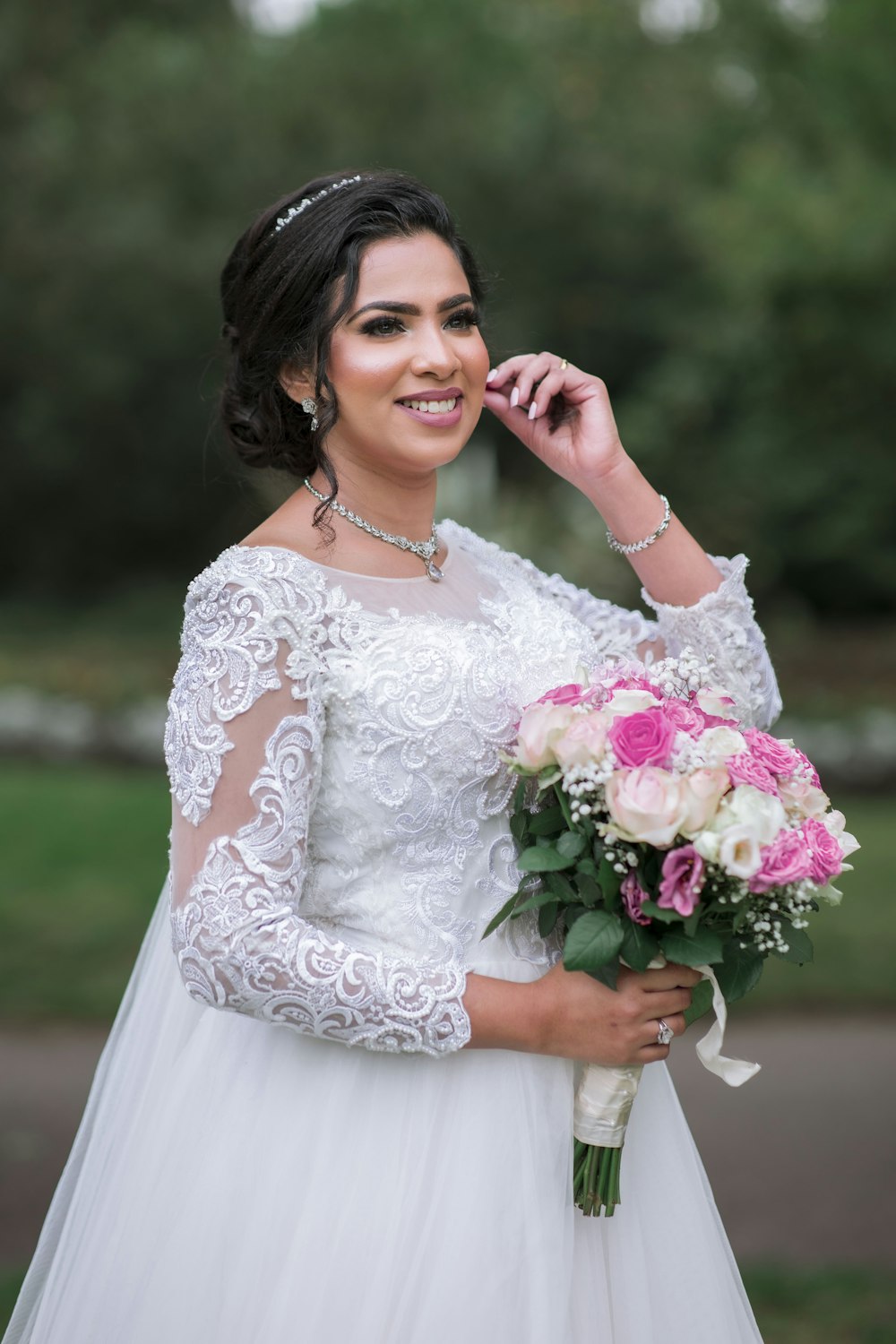 a woman in a wedding dress holding a bouquet of flowers