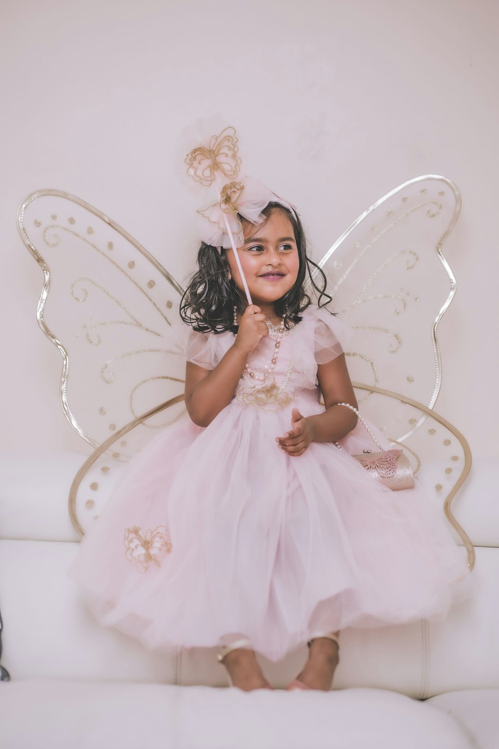 a little girl dressed in a fairy costume