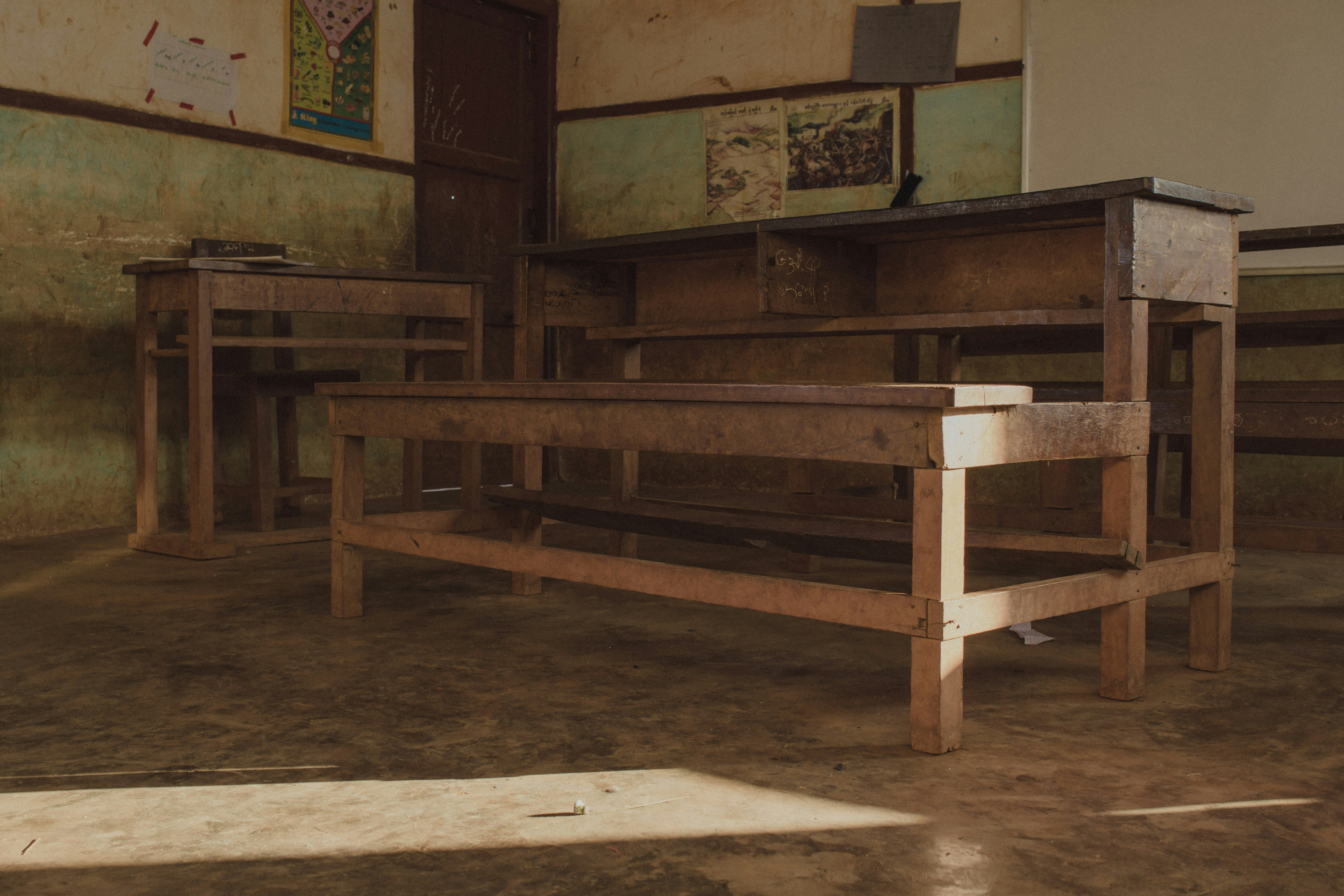 a wooden bench in a dirty room with no people
