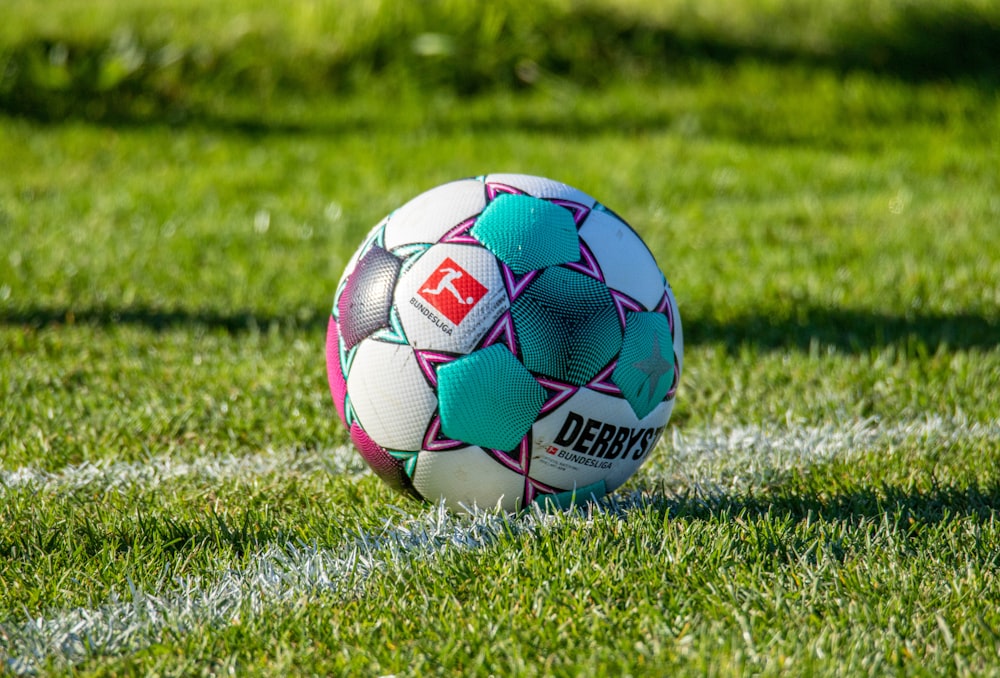 a soccer ball sitting on top of a lush green field