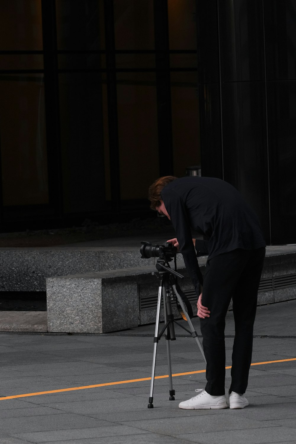 a man in a black shirt is looking at a camera