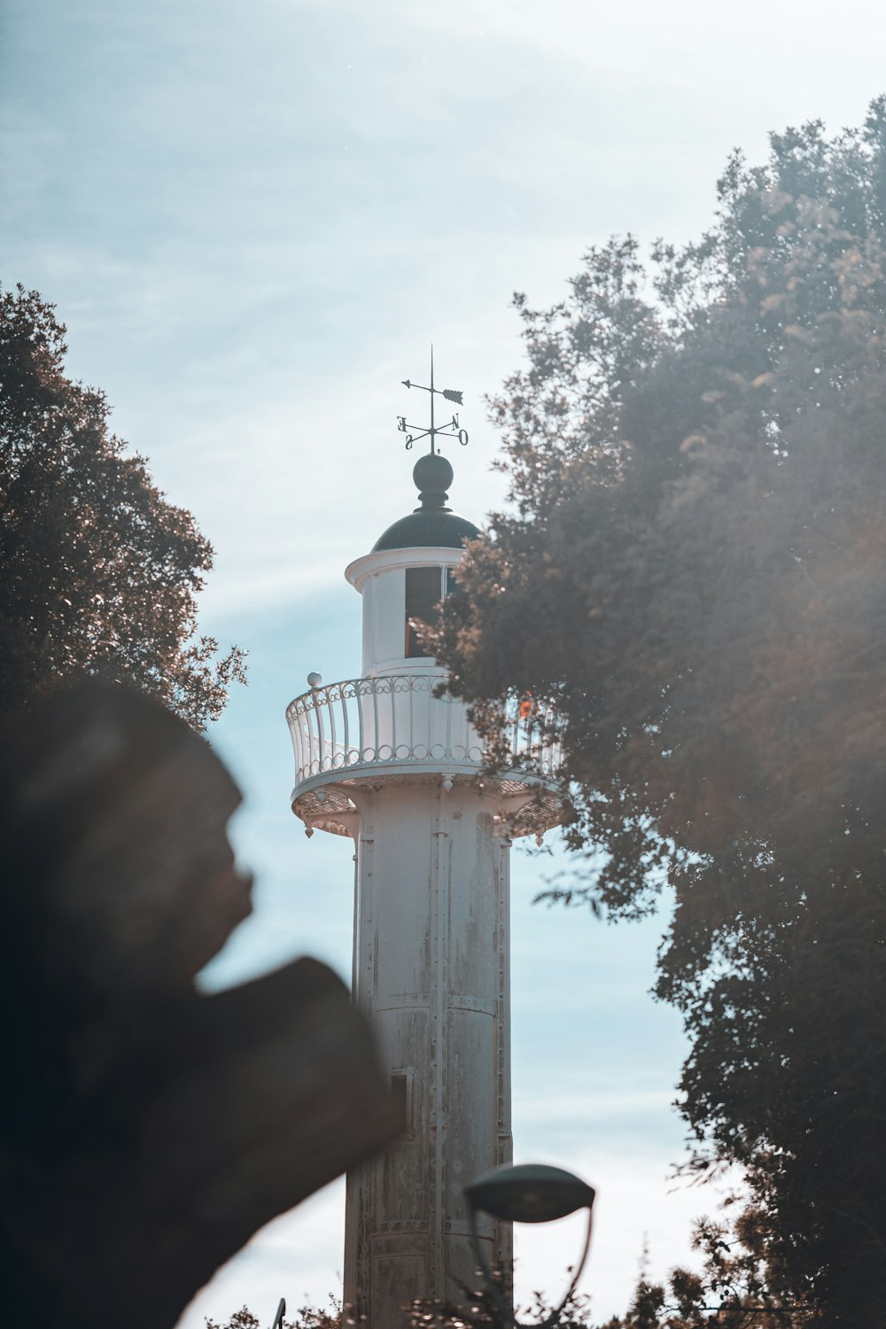 a tall white tower with a clock on top of it