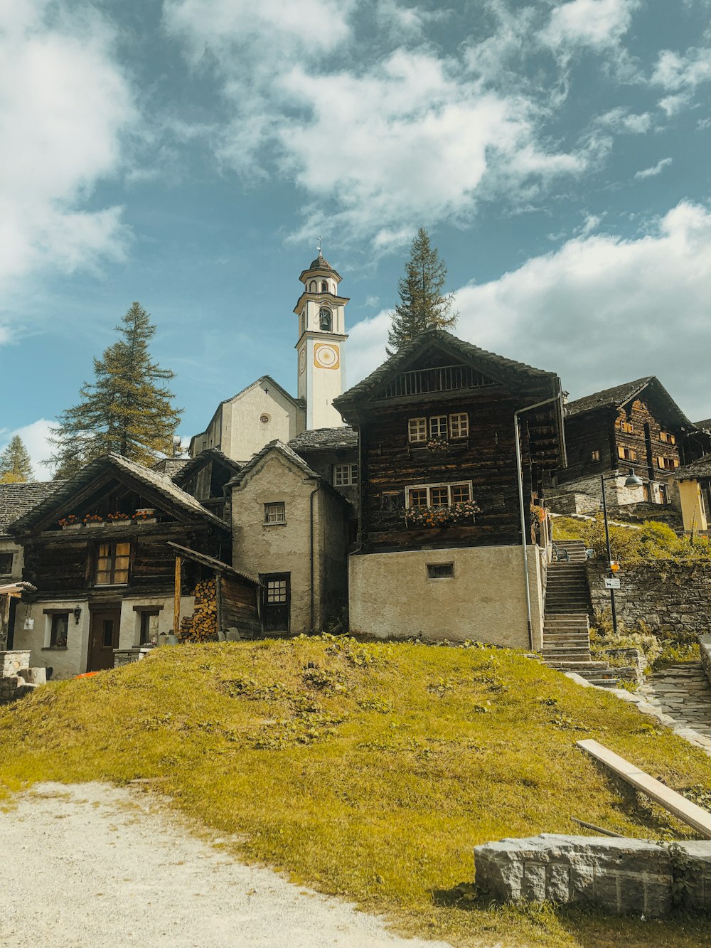 a building with a clock tower on top of a hill