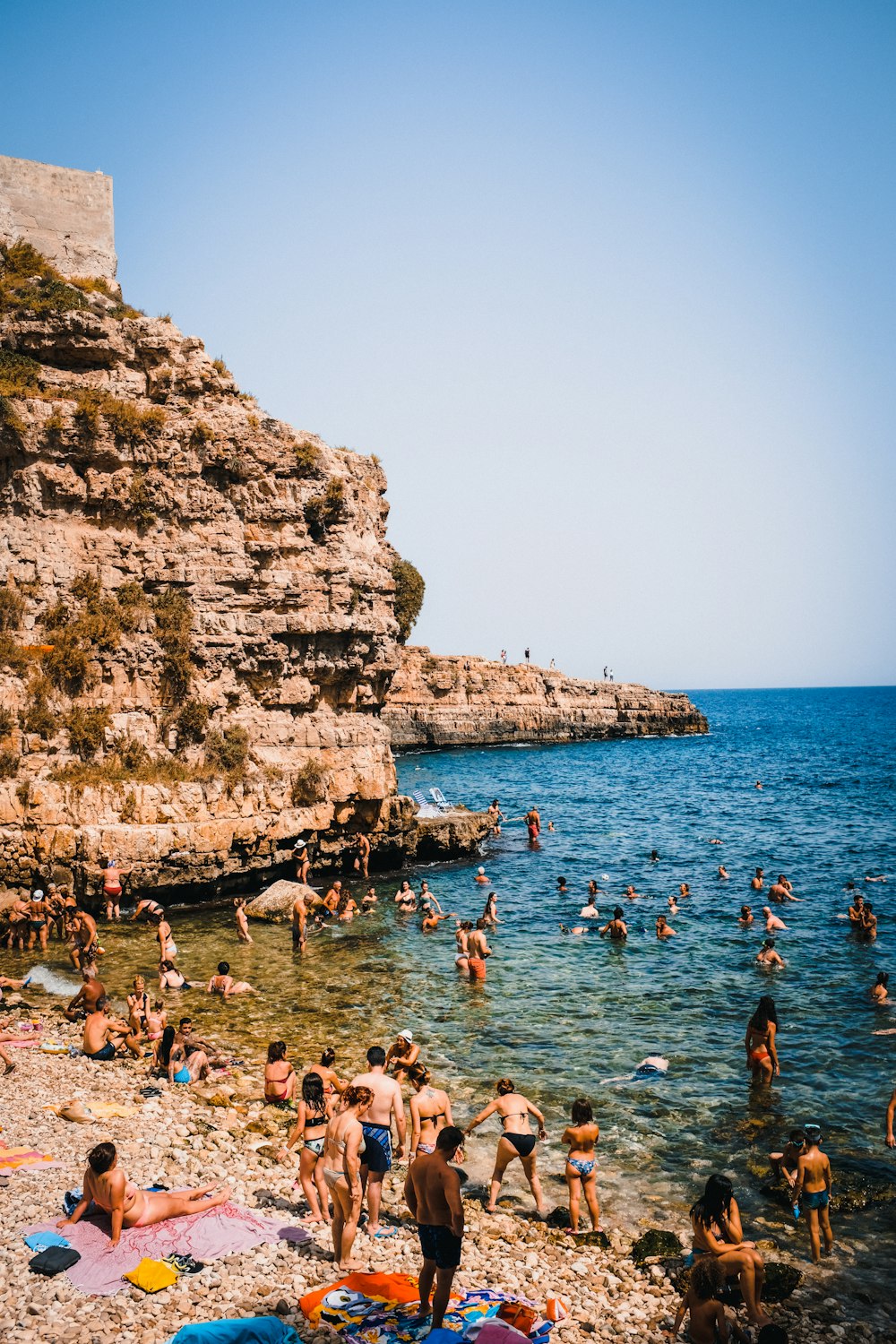 many people are on the beach and in the water