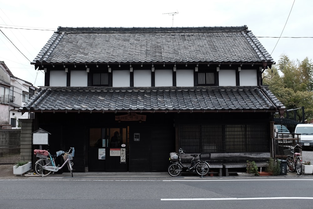 a black and white building with a bicycle parked in front of it