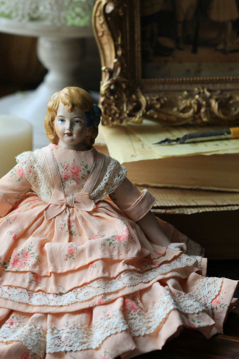 a doll sitting on a table next to a mirror