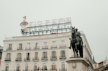 a statue of a man on a horse in front of a building