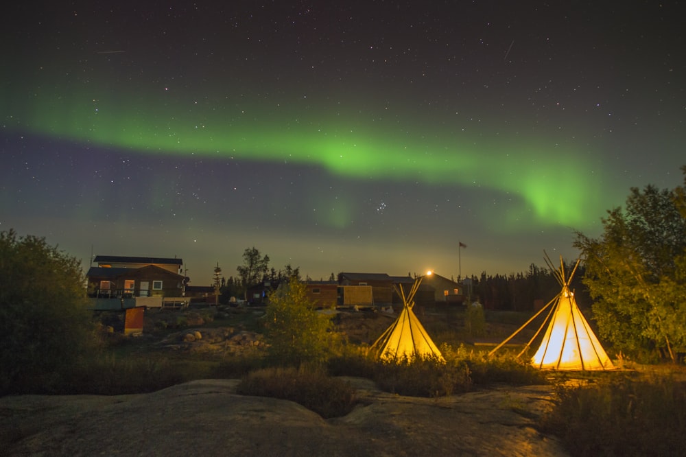 a couple of teepees that are sitting in the grass