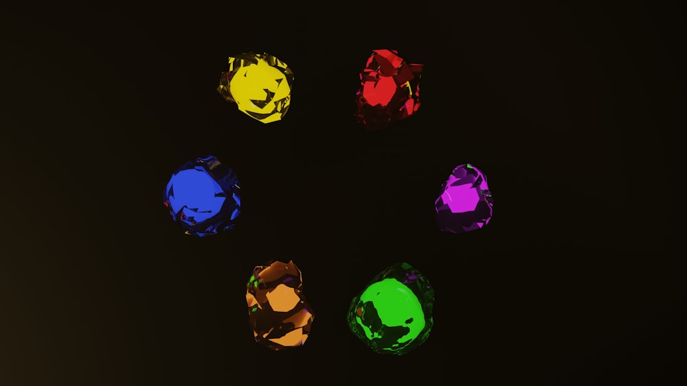 a group of different colored stones on a black background
