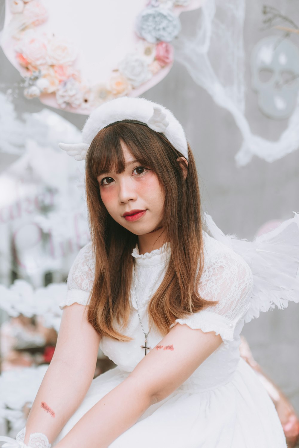 a woman in a white dress and angel wings