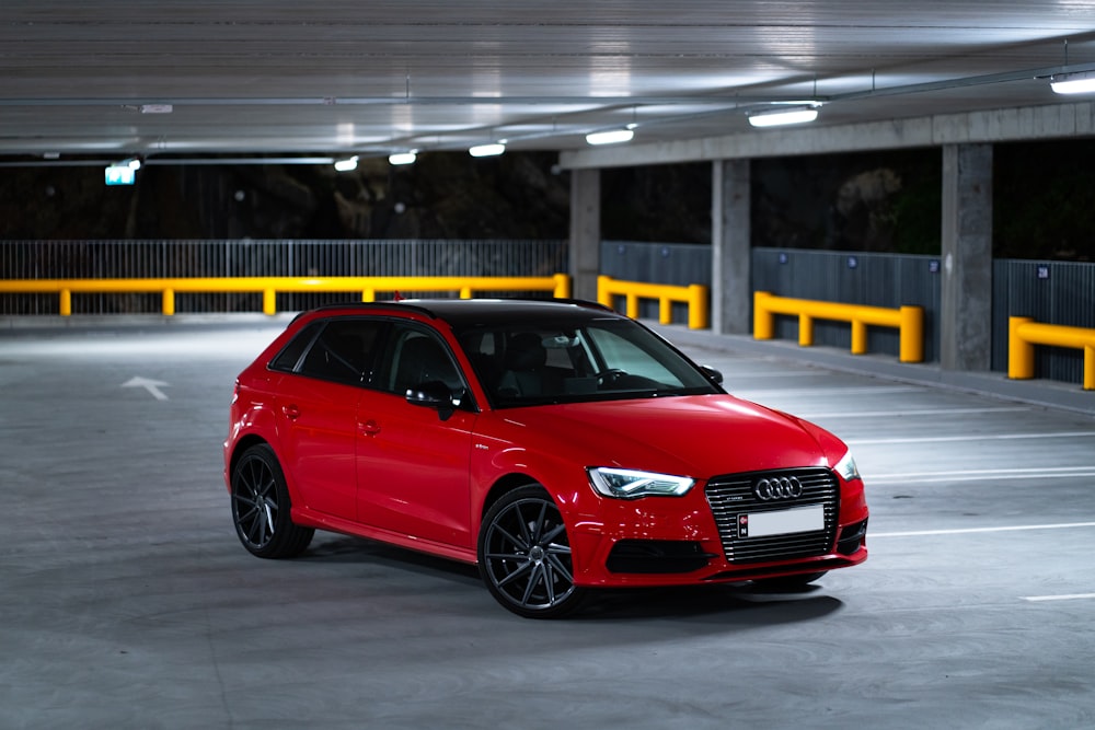 a red car parked in a parking garage