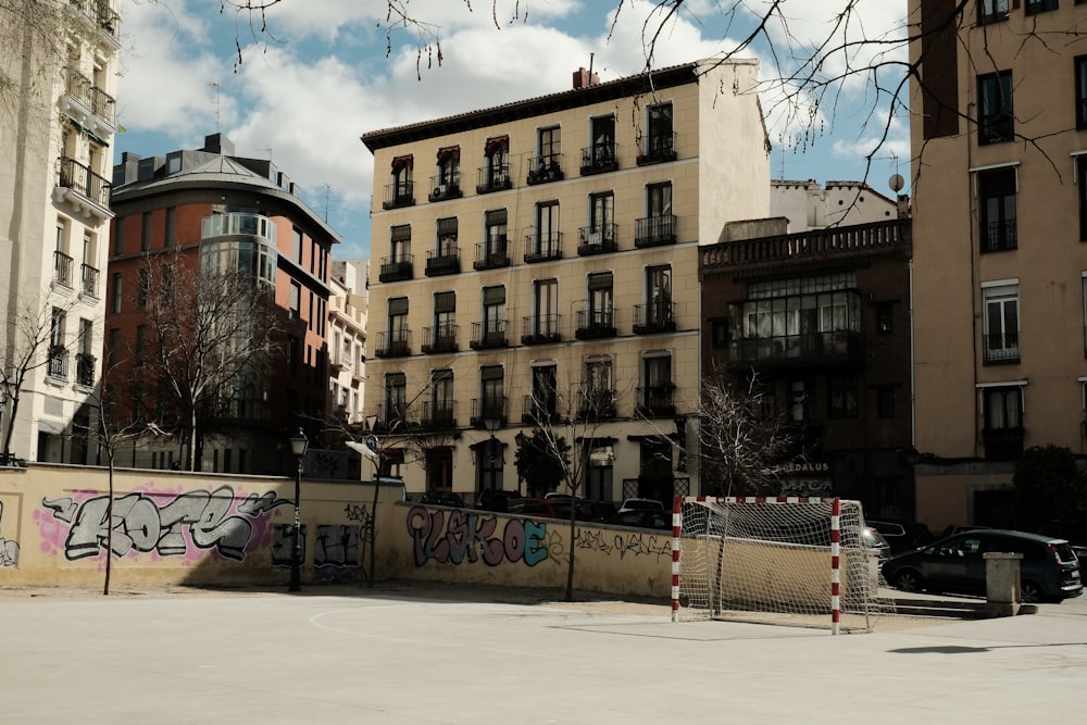 a car parked in front of a building with graffiti on it