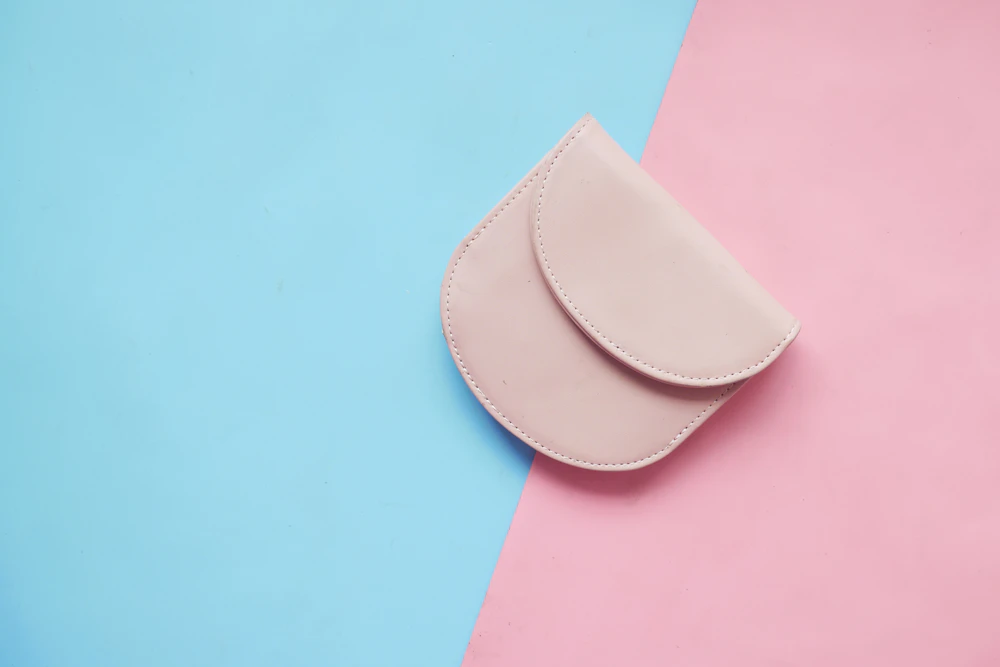 Pink wallet on a pink and blue background